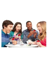 Family playing card game at table, holding a fan of colorful cards