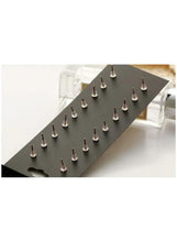 Gold geometric stud earring set with mixed shapes on black display card