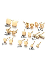 Gold geometric stud earrings set with size labels in cm on flat lay