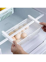 White vented plastic egg organizer bin with divider, held inside the refrigerator