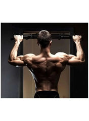 Black steel push-up bars with sponge grips mounted on a doorway bar