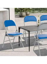 Blue folding chair with leather-style seat and backrest, angled view of white legs