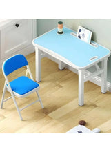 Blue folding chair with leather-style seat and backrest, side view with white frame