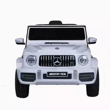 Kids electric ride-on car in white, front view with grille and round headlights