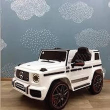 Kids electric ride-on car in white with black seat, front 3/4 view