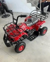 Red electric ATV quad bike side view with metal headlight guard and gray seat