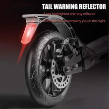 Rear wheel with disc brake and red tail warning reflector on kick scooter