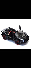 Black kids electric ride-on car with wing doors open and glowing accent lights