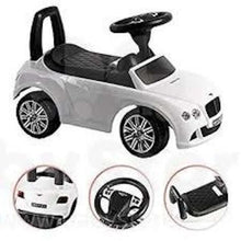 White ride-on push car with steering wheel and seat, side view