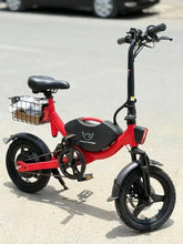 Red foldable electric bike with front basket and black seat, parked outdoors