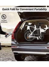 White folding electric bike loaded in a car trunk with wheels folded for portability