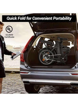 Folding electric bike loaded in a vehicle trunk, black frame with 16-inch wheels