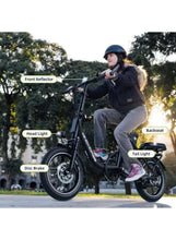 Black electric scooter with headlight, front reflector, and disc brakes, rider seated outdoors.
