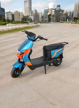 Blue electric scooter with black seat and front wheel parked on city road