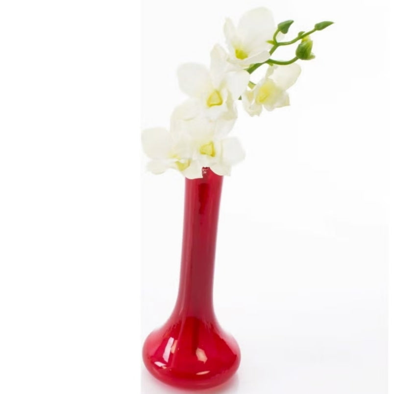 White artificial dendrobium flowers arranged in a tall glossy red vase by Huitich