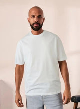 Cotton short sleeve T-shirt in white, crew neck front view on model.