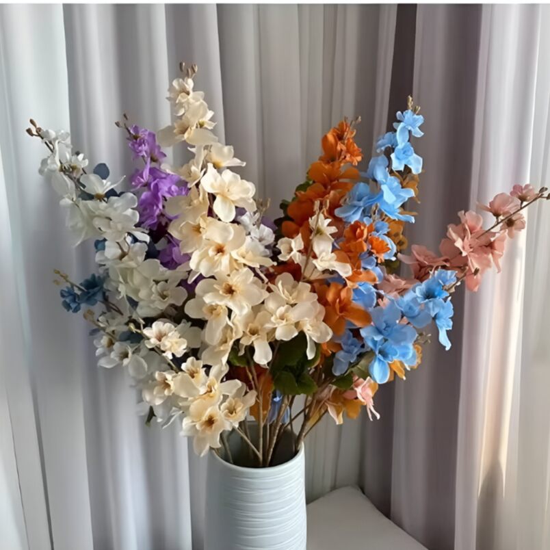 Huitich artificial flowers featuring white floral arrangements for events in a white vase with colorful accents