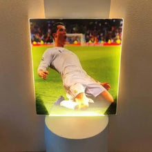 White table lamp showing glowing soccer player image in square panel