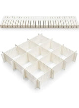 White drawer separator organizer with hinged sections and raised dividers for compartments.
