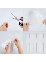 White drawer separator panel parts being aligned and connected into a segmented divider.