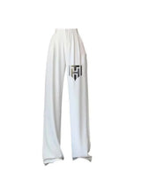 White ice-silk wide-leg pants with relaxed fit and centered logo patch