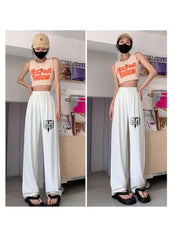 Huitich white ice silk wide leg pants modeled with a crop top, casual cap, and black sandals