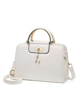 White PU leather handbag with top handles, front clasp flap, and dangling charm keychain