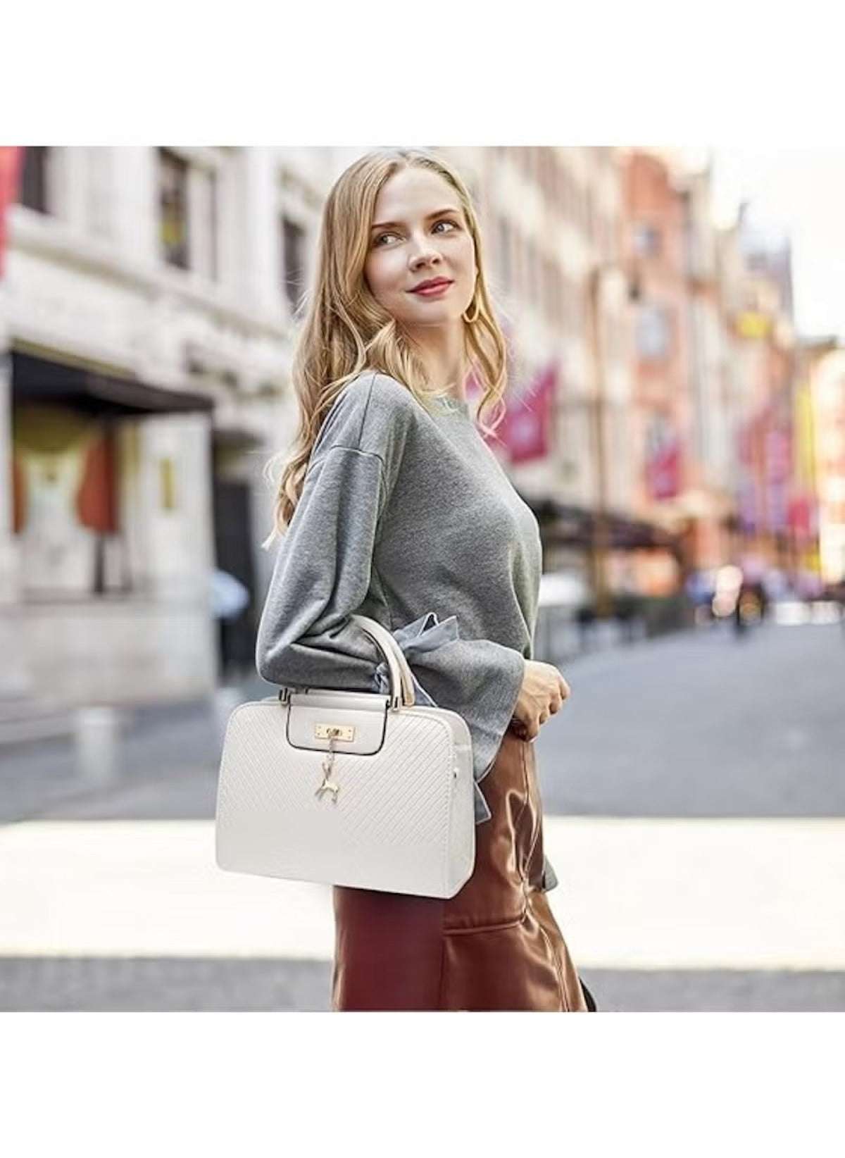 Huitich white PU leather handbag for women carried by a stylish woman in a city setting
