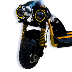 Close-up of Winner Sky E10 foldable scooter front wheel and dual headlights with yellow suspension springs