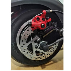 Close-up of rear wheel disc brake and red caliper on Huitich foldable electric scooter with seat