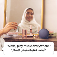 Wireless video doorbell with smart speaker on a vanity table next to makeup in front of a mirror