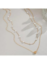 Gold-tone double-layer necklace with faux pearl beads and small heart charm