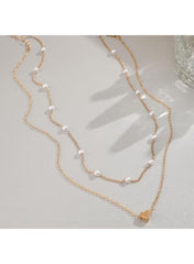 Double layer gold necklace for women featuring delicate pearls and a heart pendant