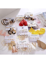 Assorted fashion earring set with hoop, stud, and tassel styles on display cards