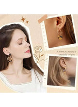 Gold-tone statement hoop and tassel earrings with dangling charm accents