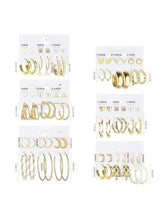 Gold-tone fashion earring set on cards: hoops, studs, and heart/pearl dangle styles