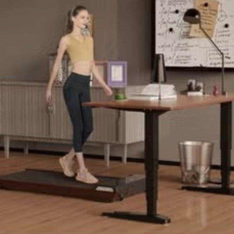 Huitich wood grain portable treadmill with woman walking beside a standing desk in a home office