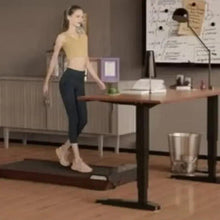 Portable treadmill with dark running belt and wood-grain deck, person walking