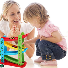 Child playing with colorful wooden car ramp toy for kids while mother watches with smile