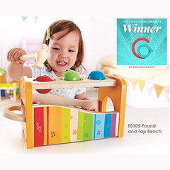 Child playing with colorful wooden music set for kids featuring a pound and tap bench by Huitich