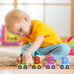 Child playing with Huitich wooden toy train for early learning featuring colorful ABCD letters
