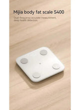 White smart body scale on floor with LED markings and four circular sensors