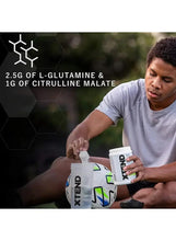 BCAA electrolyte supplement jar held by athlete, 2.5g L-glutamine and 1g citrulline