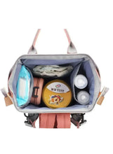 Open pink baby travel bag showing interior compartments and side bottle pockets
