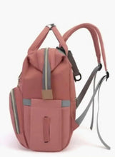 Pink baby travel bag with carry handle and long shoulder strap, front zipper