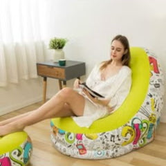 Woman relaxing on a yellow graffiti bean bag chair by Huitich in a bright living room