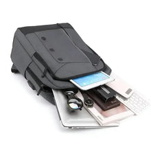 Gray backpack open on side, showing compartments for phone, cards, and charger.
