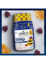 Zarbee's sleep gummies bottle with strawberry gummies and honeycomb pieces around it